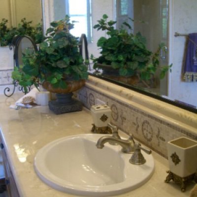 Large Vanity Mirror Accentuates Marble Counters